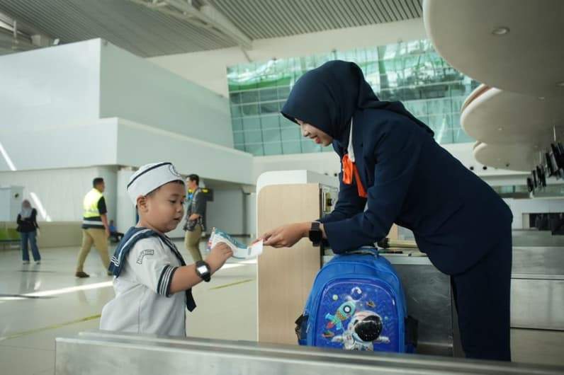 Seorang anak memperlihatkan tiket pesawat usai melakukan proses check-in di loket Bandara Internasional SAMS Sepinggan Balikpapan. (Foto: Bandara SAMS Sepinggan Balikpapan)